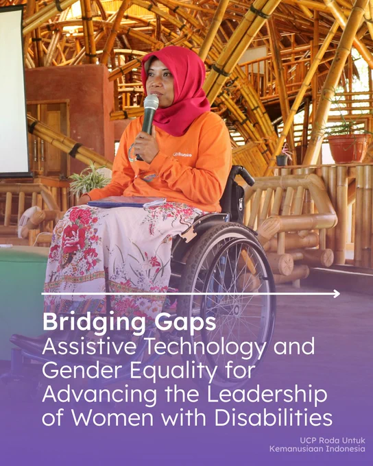 A woman wearing a bright pink headscarf and an orange shirt speaks into a microphone while seated in a wheelchair. She is addressing an audience inside a large bamboo structure with exposed bamboo beams and wooden furnishings. A notebook rests on her lap as she speaks. The image is overlaid with the text: “Bridging Gaps: Assistive Technology and Gender Equality for Advancing the Leadership of Women with Disabilities.”