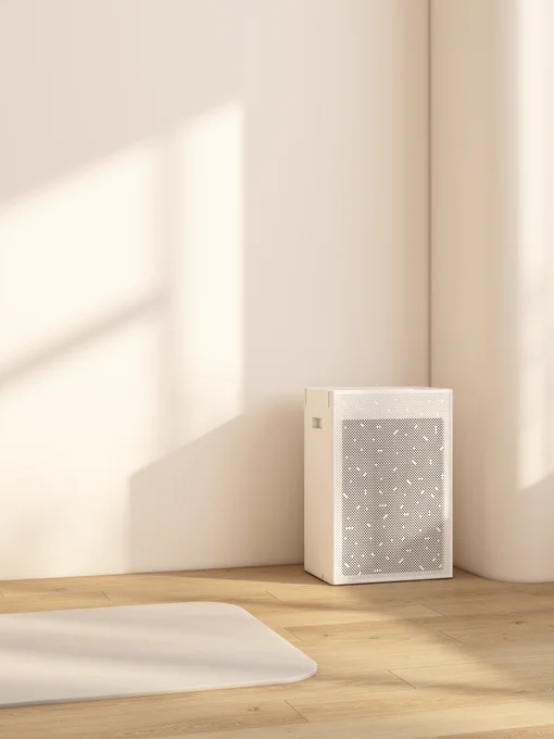 White smart air purifier in a bright yoga studio corner with sunlight on the wall and wooden floor.