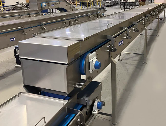 Popcorn Travels Half a Football Field from Salter to Hopper 
Multi-Conveyor’s sanitary raw snack food transport and elevation system consisting of five (5) conveyor sections, totaling over 50 yards (150 ft.).