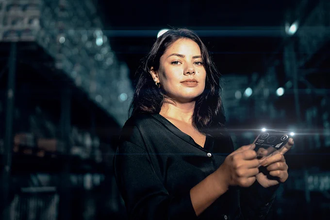 Portrait of a confident person holding a digital device