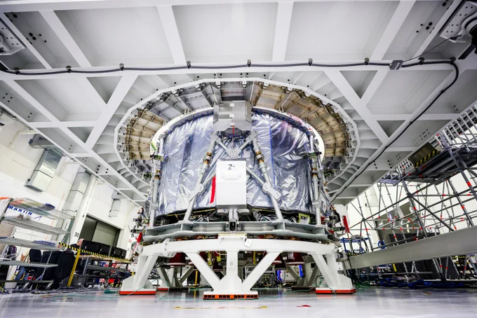 The third European Service Module arriving at NASA's Kennedy Space Center. A grey cylinder in the middle of a cleanroom.