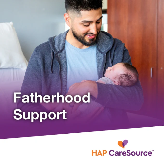A person gently holds a baby in a cozy indoor setting. The text on the image reads "Fatherhood Support." The logo for HAP CareSource is displayed at the bottom.