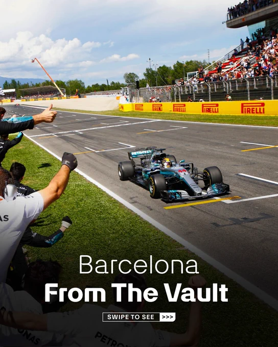 An image of Lewis Hamilton crossing the line to win the 2017 Spanish Grand Prix on the circuit de Barcelona-Catalunya. Mercedes staff and engingeers can be seen cheering in the left of shot. Text at the bottom of the shot reads 'Barcelona, From the Vault, Swipe to See'