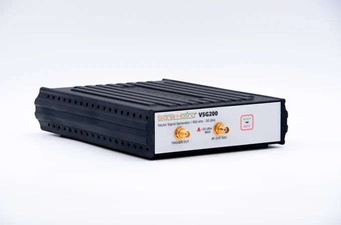 Signal Hound's new VSG200 vector signal generator sits on a white surface against a white background. It has an outer black protective shell, two ports on the front, and a "Ready/Busy" light indicator.