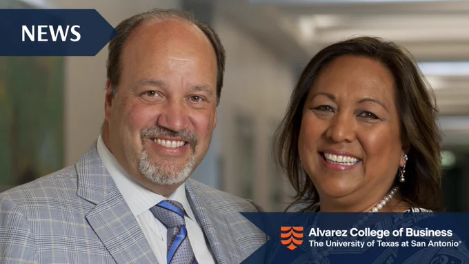 Two professionals standing indoors at Alvarez College of Business, dressed in formal attire with blurred faces.