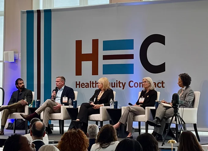Five people on stage at the Health Equity Compact.