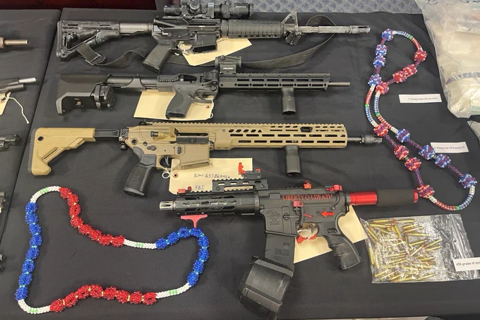 A variety  of firearms, ammunition, and gang paraphenalia.