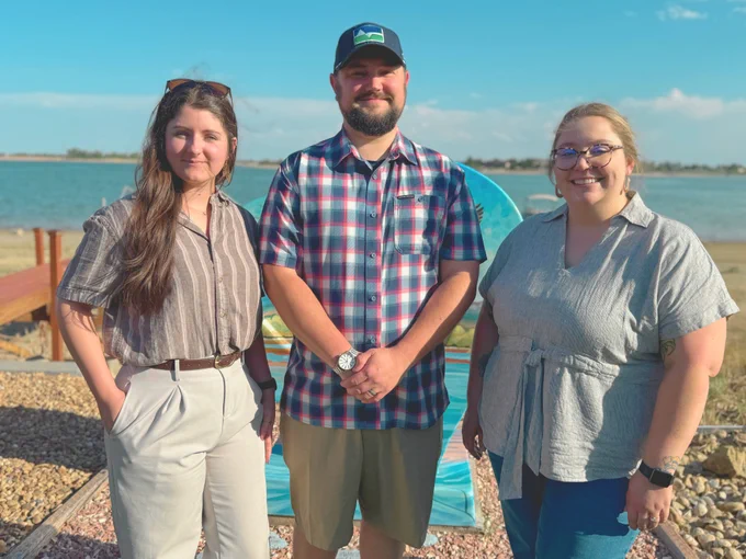 Three Leadership Loveland graduates stand in front of a lake. From left to right, Catharine Kellogg, Chris Koponen and Ali Pascell.