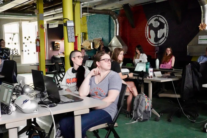 Students pay attention to a demonstration at the Fab Lab. 