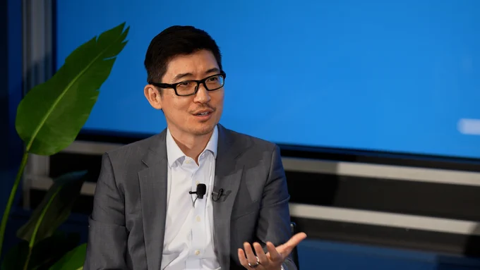 Man speaking in front of screen