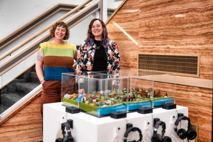 Artists standing behind their project created for the Community Assembly, highlighting the role of 15-minute neighborhoods