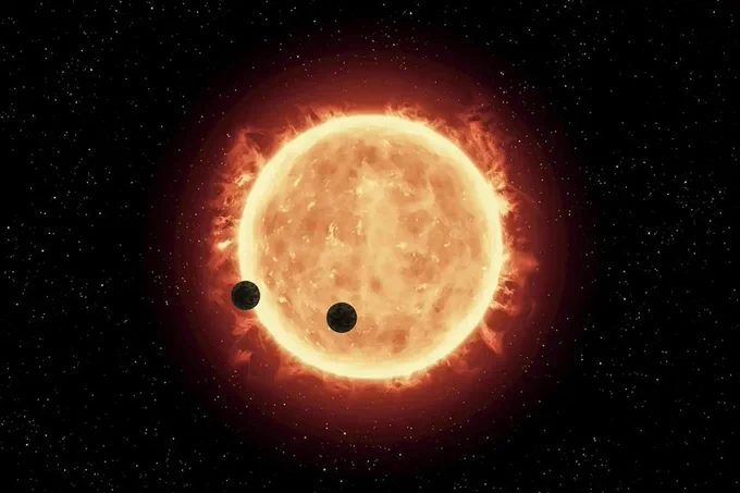 An artist’s impression of a star with two planets transiting across it
