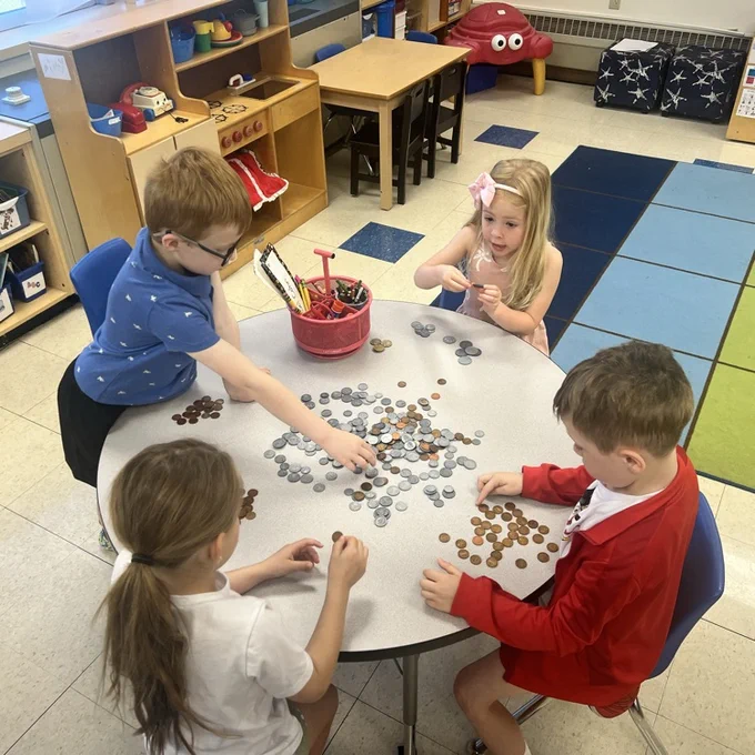 KRO sorts quarters, dimes , nickels and pennies in math