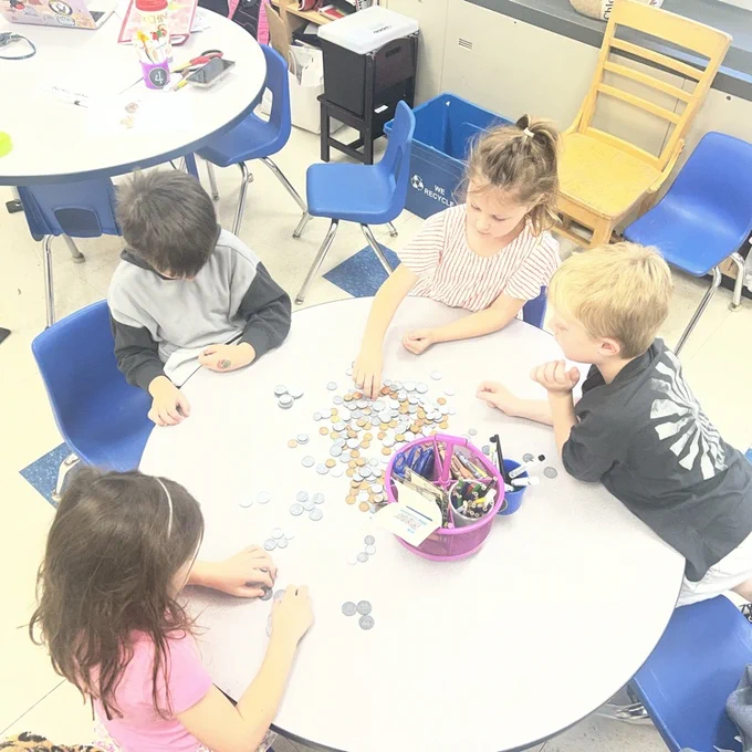 KRO sorts quarters, dimes, nickels and pennies in math