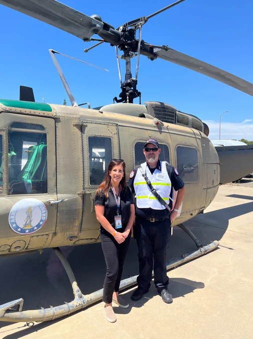 CalHHS and EMSA leaders in front of a helicopter.