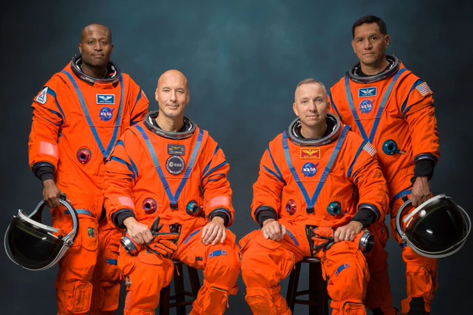 Andre Douglas, Luca Parmitano, Randy Bresnik, and Frank Rubio pose together in their orange spacesuits.