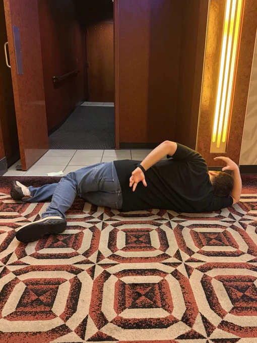 Krazy Ken lying dead on the floor outside a movie theater auditorium. You see him from behind, lying in the “dead Peter Griffin” pose.
