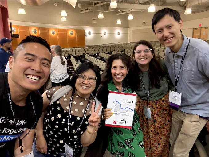 Group selfie of George and four friends from Rutgers University holding up a book titled "Bonner on the Banks"