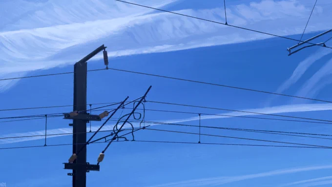 Digital painting of a bright blue sky, featuring crisscrossing contrails, and overhead train lines, a mess of cables hanging on a utility pole.