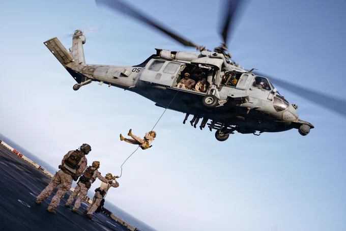 U.S. Marines and Sailors with Maritime Raid Force, 31st Marine Expeditionary Unit, rappel out of an MH-60S Sea Hawk assigned to Helicopter Sea Combat Squadron (HSC) 25, during rappelling training aboard forward-deployed America class assault ship USS Tripoli (LHA 7) in the U.S. Central Command area of responsibility, May 27, 2026. (U.S. Marine Corps photo by Lance Cpl. Victor Gurrola)\n\n