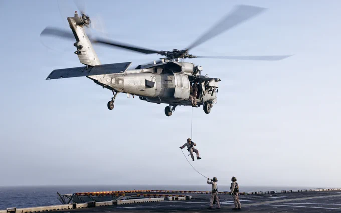 U.S. Marines and Sailors with Maritime Raid Force, 31st Marine Expeditionary Unit, rappel out of an MH-60S Sea Hawk assigned to Helicopter Sea Combat Squadron (HSC) 25, during rappelling training aboard forward-deployed America class assault ship USS Tripoli (LHA 7) in the U.S. Central Command area of responsibility, May 27, 2026. (U.S. Marine Corps photo by Lance Cpl. Victor Gurrola)\n\n