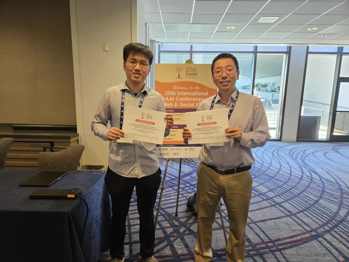 PhD student Ruichen Yao (left) and Professor Dong Wang (right) smile while holding up their award certificates for Best Dataset Paper Award. 