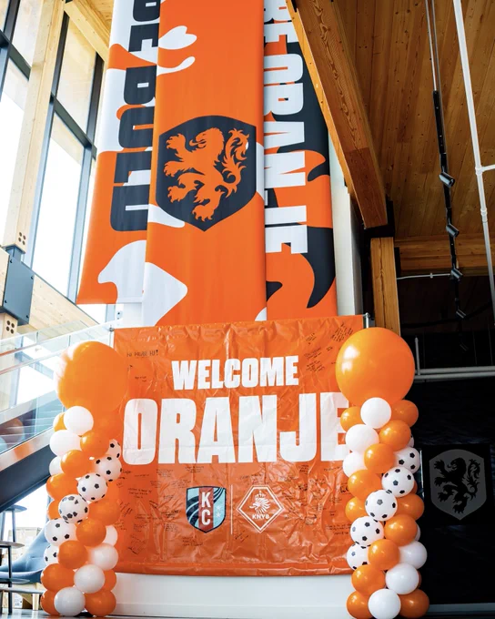 Inside of our training center with an orange “welcome oranje” banner at the base of the newly hung up Netherlands banners