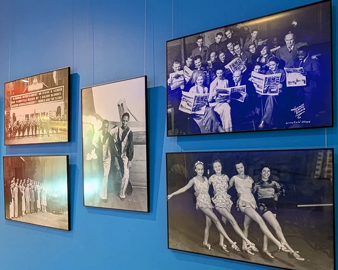 Gallery wall with four vintage black-and-white photos depicting groups of people in various activities and poses.