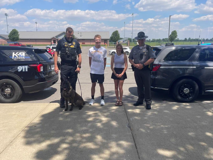 Marion Lt. Elliot and K-9 Ranger, Colt and Finley from River Valley High School, and Sgt. Smith, Marion Post, at a sendoff for the state track and field meet. 

