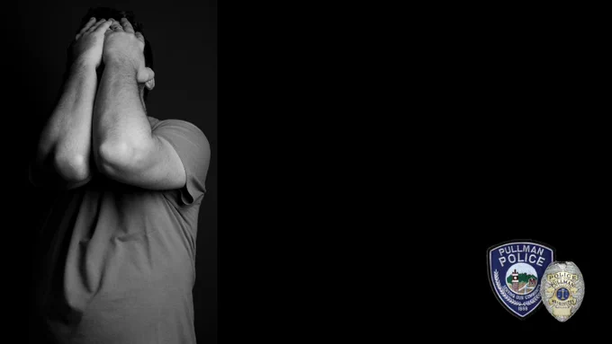 Black and white image of a person holding both hands over their face.