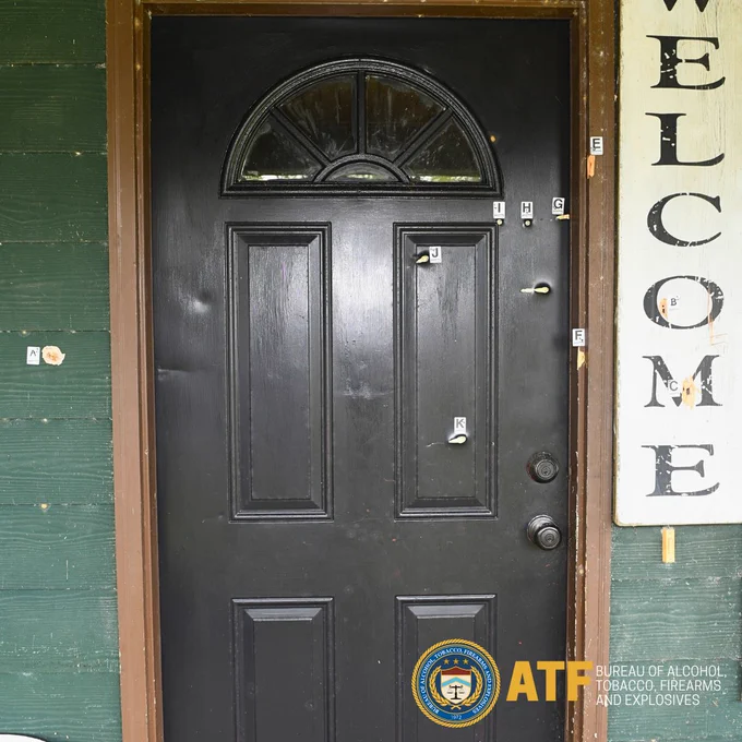 Outside of front door of John Caleb Allen's home in Bristol, Florida,  showing bullet holes.