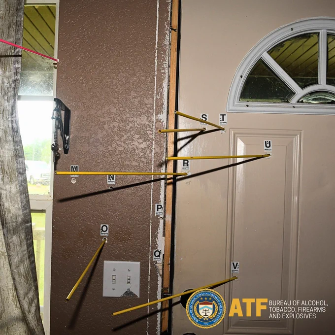 Inside of front door of John Caleb Allen's home in Bristol, Florida,  showing bullet holes.