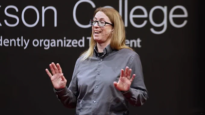 Dr. Kristin Mudge speaks on the TEDx stage. 