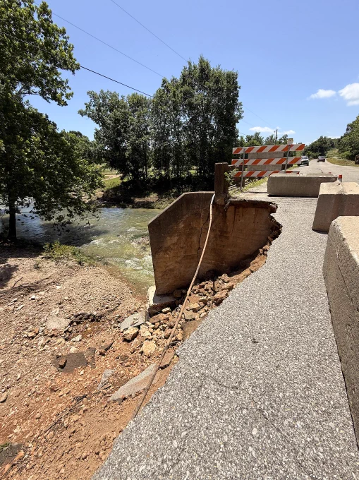photo shows damage to a road and bridge