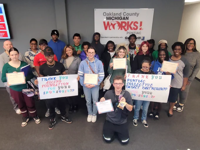 iamPontiac summer internship participants pose together with signs that read "Thank you Ascend Foundation for Your Sponsorship." and "Thank you Pontiac Collective Impact Partnership for Your Sponsorship."