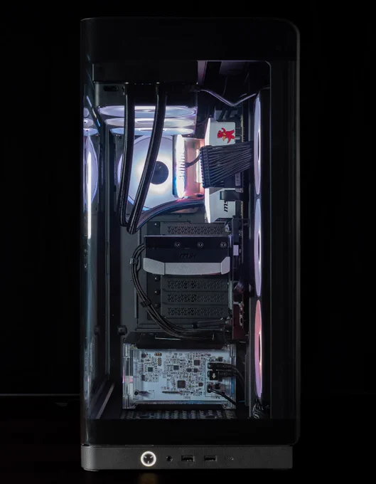 A side view of black CORSAIR 4500X case, featuring new the new TITAN II ULTRA AIO and HX1000i SHIFT Crystal.  The background is dark, making the colors of the fans and interior much more intense in brightness and color. 