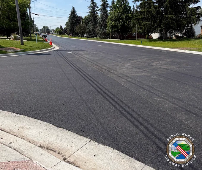 Freshly paved section of Borden Road with new asphalt.