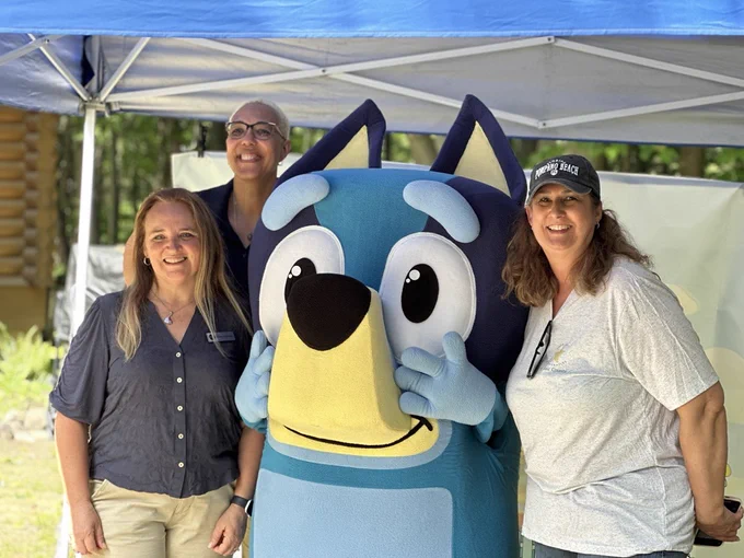 A special guest helped make Celebrate Your Child Literacy Day even more memorable! Bluey entertained attendees and joined Dr. Sophia Lafayette-Lause, MiLEAP Director of Early Learning and Family Supports; Dawn Kalkman, MiLEAP Education Consultant Manager; and Becky Gorinac, St. Clair County RESA Director of Early Childhood Services, for a photo during the record-breaking literacy event at Pine River Nature Center in Goodells, Michigan.

