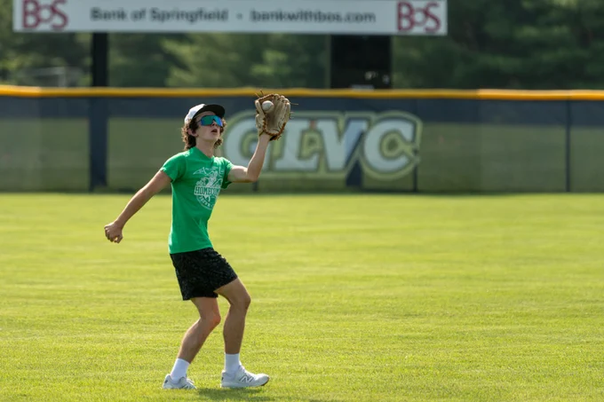 Camper tracks a fly ball in the outfield during a fielding drill at the UIS Baseball youth camp.
