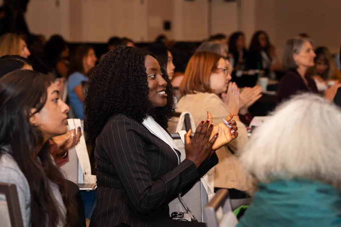 Audience members clapping at Policy Action Institute.