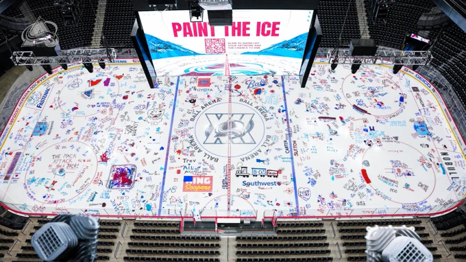 An overhead shot of the Ball Arena ice after the Paint The Ice event where fans can write on the ice with their names and messages
