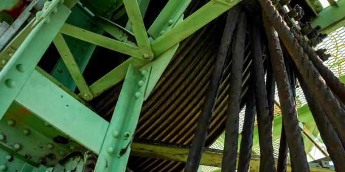 A close-up view of structural components of the Interstate Bridge that powers the lift span, with a reel of corroded cables.