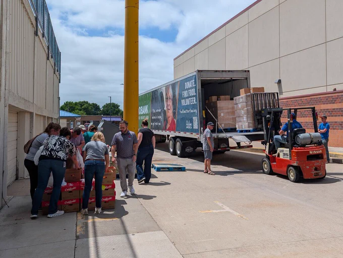 NPPS staff and volunteers unloading food from truck.