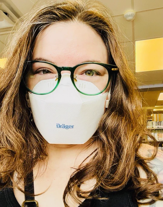 I'm wearing a white drager mask and green framed glasses.