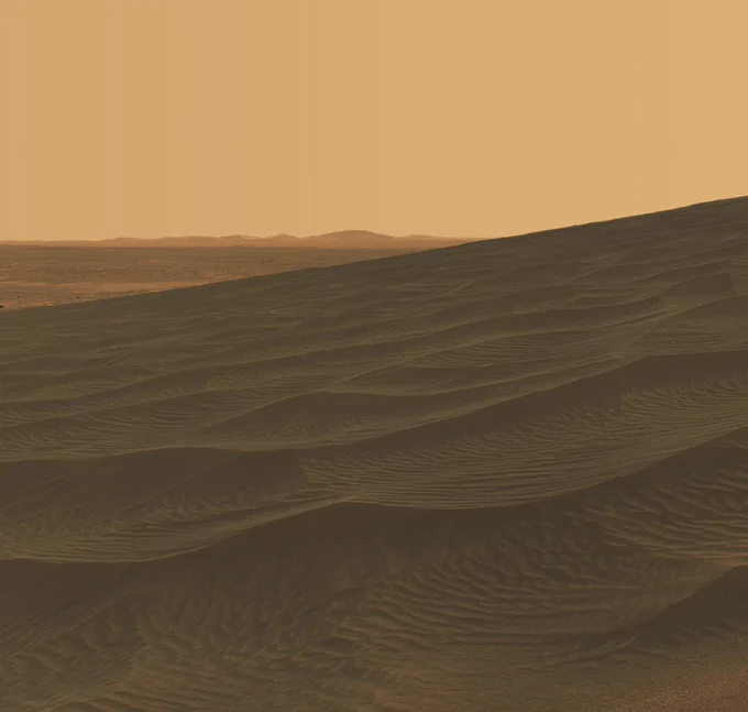NASA's Mars Exploration Rover Spirit welcomed the beginning of 2006 on Earth by taking a striking panorama of intricately rippled sand deposits in Gusev Crater on Mars. This is an approximate true-color rendering of the "El Dorado" ripple field provided by Spirit. Spirit used the Pancam's 750-nanometer, 530-nanometer and 430-nanometer filters to capture the colors on Mars. Scientists  eliminated seams between individual frames in the peachy sky portion of the mosaic to better simulate the vista a person standing on Mars would see. Hills are visible in the far distance. Credit: NASA/JPL-Caltech/Cornell