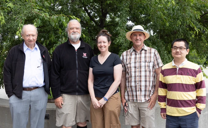 An outdoor group photo of (from left) James Van Etten, David Dunigan, Jessica Corman, John DeLong and Qiuming Yao. (Cheyenne Rowe/Research and Innovation)