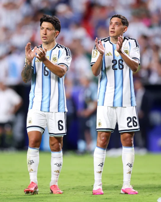 Lisandro Martinez and Nahuel Molina applaud their fans after Argentina beat Algeria at the World Cup.