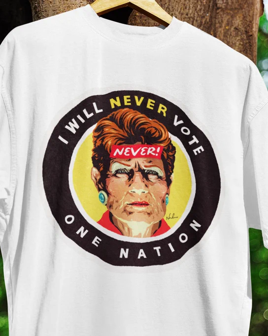 White T-shirt featuring an illustrated portrait of Pauline Hanson with a red headband reading “NEVER!”. Surrounding text reads “I Will Never Vote One Nation”. The design is rendered in a bold retro political poster style with black, yellow, red and cream tones.