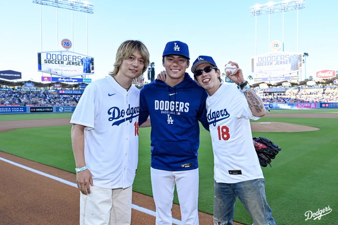 A photo of Yoshinobu Yamamoto with Taka and Toru from ONE OK ROCK.