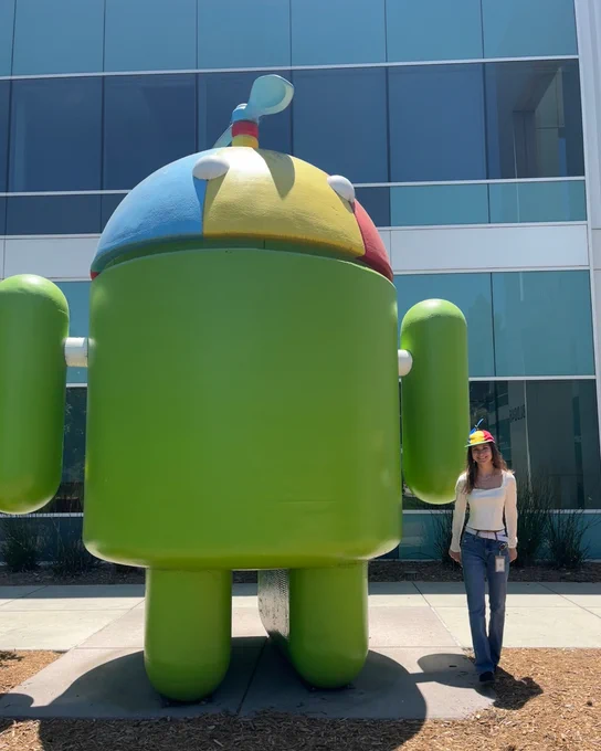 Google intern standing next to Android statue